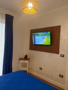 a bedroom with a tv on a wall at Lili room in Focşani