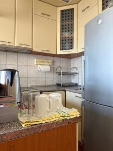 a kitchen counter with white mugs on a towel at Dunav View Residence - River View Free Parking in Belgrade