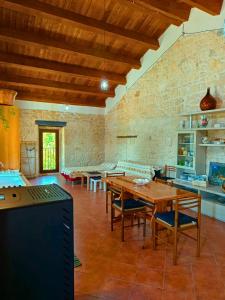 a kitchen with a table and chairs in a room at Casa Rurale Pietra Bianca in Roccamorice +60 photos