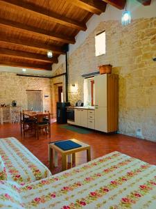 a room with two beds and a kitchen and a table at Casa Rurale Pietra Bianca in Roccamorice