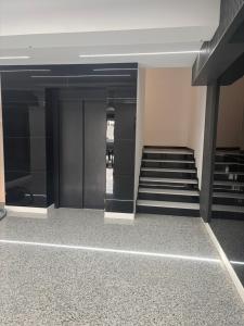 a staircase in a building with black and white floors at Lili room in Focşani +4 photos