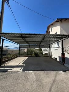 an empty parking lot with a metal structure at Apartman Šarić in Neum