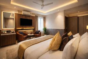 a hotel room with a large bed and a television at Airport Vistara Cove By Velocity Group Terminal 2,3 Delhi IGI Airport With free Airport Pickup in New Delhi