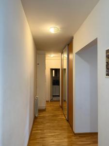a hallway with white walls and wooden floors at Dunav View Residence - River View Free Parking in Belgrade +2 photos