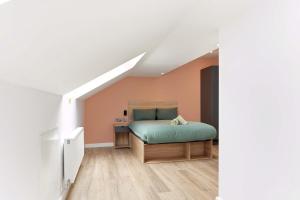 a bedroom with a bed in a attic at Modern Studio in Central Leeds in Leeds