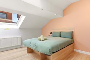 a bedroom with a bed with a teddy bear on it at Modern Studio in Central Leeds in Leeds