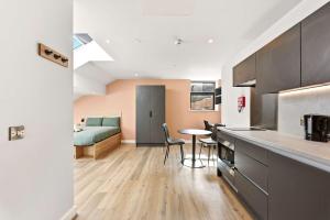 a kitchen and living room with a bed in a room at Modern Studio in Central Leeds in Leeds