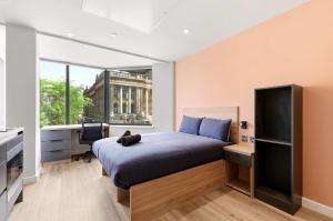 a bedroom with a bed and a desk and a television at Modern Studio in Central Leeds in Leeds +27 photos