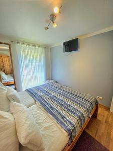 a bedroom with a bed and a tv on the wall at Köhler-Glowienka, Ute App Nr 3 in Schönberger Strand