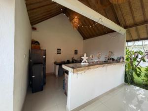 a kitchen with a counter and a refrigerator at Jordan Guest House in Uluwatu