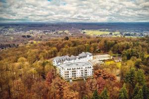 an aerial view of a building in a forest at Radisson BLU Balmoral in Spa