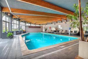 a swimming pool in a building with a large building at Radisson BLU Balmoral in Spa
