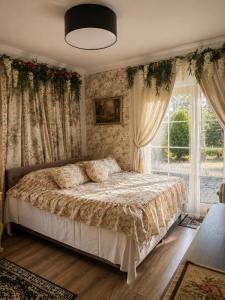a bedroom with a bed and a window at Apartamenty Kapitańskie in Oława +8 photos