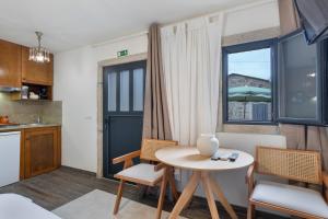 a room with a table and chairs and a window at Casa do Monte - Monção in Poças do Monte