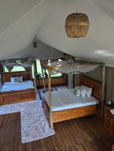a bedroom with two beds in a tent at Tctc & Camp in Shikurufumi +38 photos