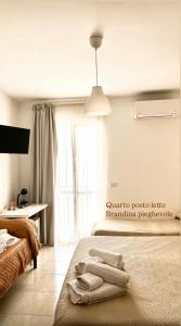a bedroom with a bed with towels on it at La Quiete in Scilla