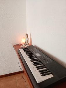 a small figurine sitting on top of a keyboard at Oro y Miel II en pleno centro de Chascomús in Chascomús +5 photos