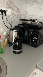 a kitchen counter with a coffee pot and a toaster at Relax Apratman in Gornji Milanovac
