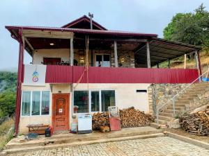 a house with a red roof and a staircase at The Kalavan Retreat Center in Chambarak
