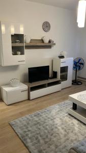 a living room with a flat screen tv on a wall at Relax Apratman in Gornji Milanovac