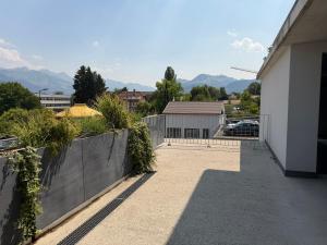 a balcony of a house with mountains in the background at Bulle de rêve jacuzzi in Bulle