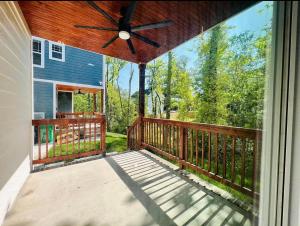 a screened porch of a house with a ceiling fan at Charlotte NC in Charlotte