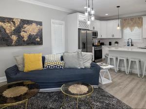 a living room with a blue couch and a kitchen at Charlotte NC in Charlotte +4 photos