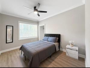 a bedroom with a bed and a ceiling fan at Charlotte NC in Charlotte