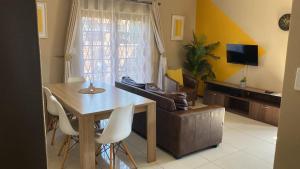 a living room with a table and a couch at Tumi's Home away- 3 Bedroom in eMalahleni