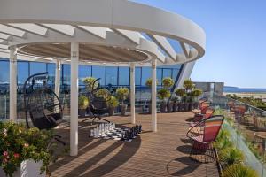 a pavilion with chairs and tables on a deck at Sheraton Nice in Nice