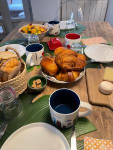 a table topped with plates and cups of coffee and pastries at À Plus, Lectoure in Lectoure