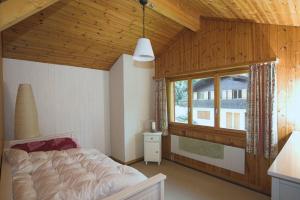 Voodi või voodid majutusasutuse Chalet Valdonga toas
