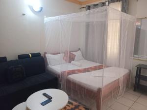 a living room with two beds and a couch at Silent breeze home in Mombasa