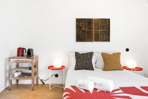 a bedroom with a white bed and two side tables at GuestReady - Freixo Apartments in Porto