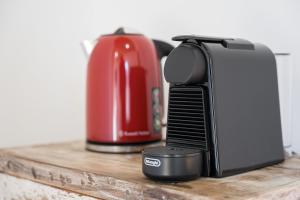 a toaster sitting on a counter next to a coffee maker at GuestReady - Freixo Apartments in Porto +11 photos