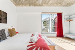 a bedroom with a large bed with red curtains at GuestReady - Freixo Apartments in Porto