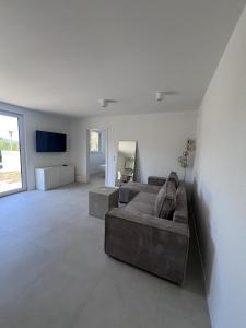 a living room with a couch and a television at Ferienwohnung Casa Panorama in Beuren