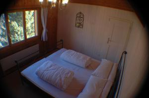 Voodi või voodid majutusasutuse Chalet Valdonga toas