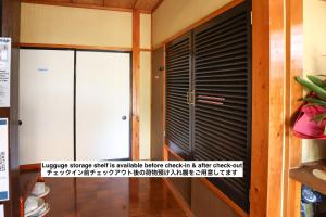 a door with a shutter in a room at DON chan GuestHouse Nikko ,7 minutes walk from Imaichi Station in Nikko +50 photos