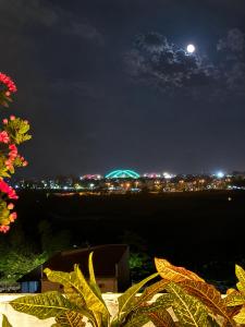 a view of a city at night with the moon at Athena Hotel Huế in Hue +49 photos