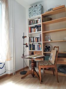 a room with a desk and a chair and a book shelf at Bern room near Main Station in Bern