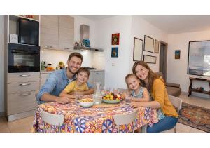 a man and two children sitting at a table at Pupi Catania Etna Farm in Catania