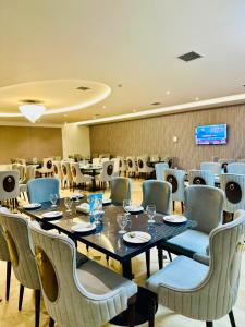 a dining room with a table and chairs at Ambassador Hotel in Lahore