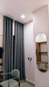 a room with a mirror and a green curtain at Hotel ROYAL DC in Alīgarh