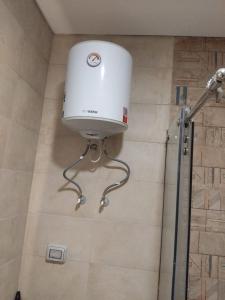 a water tank in a shower in a bathroom at Cozy studio in sahel in El Alamein