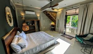 a bedroom with a large bed and a staircase at Beyond Alma Del Rio in Cristo Rey +55 photos