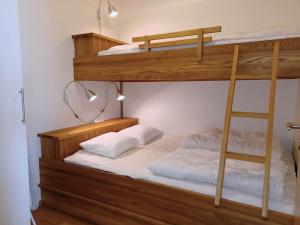 two bunk beds in a room with a ladder at Dählie Åre Torg Apartments in Åre