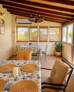 a dining room with two tables and chairs and windows at Solmara in Lozenets