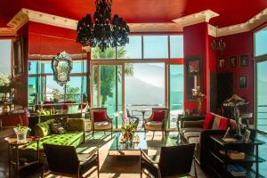 a living room filled with furniture and a large window at La Suite by Dussol in Rio de Janeiro