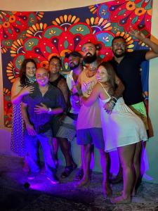a group of people posing for a picture in front of a painting at Penny House Hostal in David +56 photos